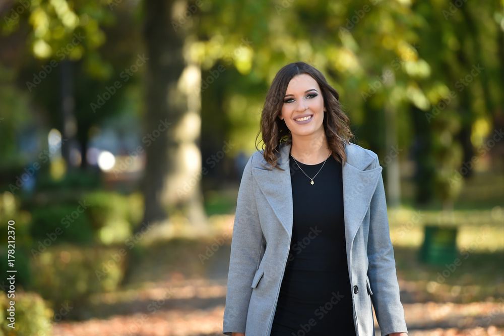one fashion woman walk in a park in autumn one fashion woman walk in a park in autumn
