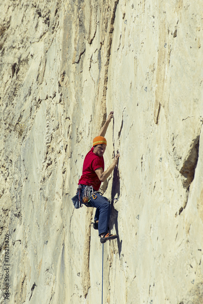 The climber climbs to the top of the mountain. The climber climbs to the top of the mountain.