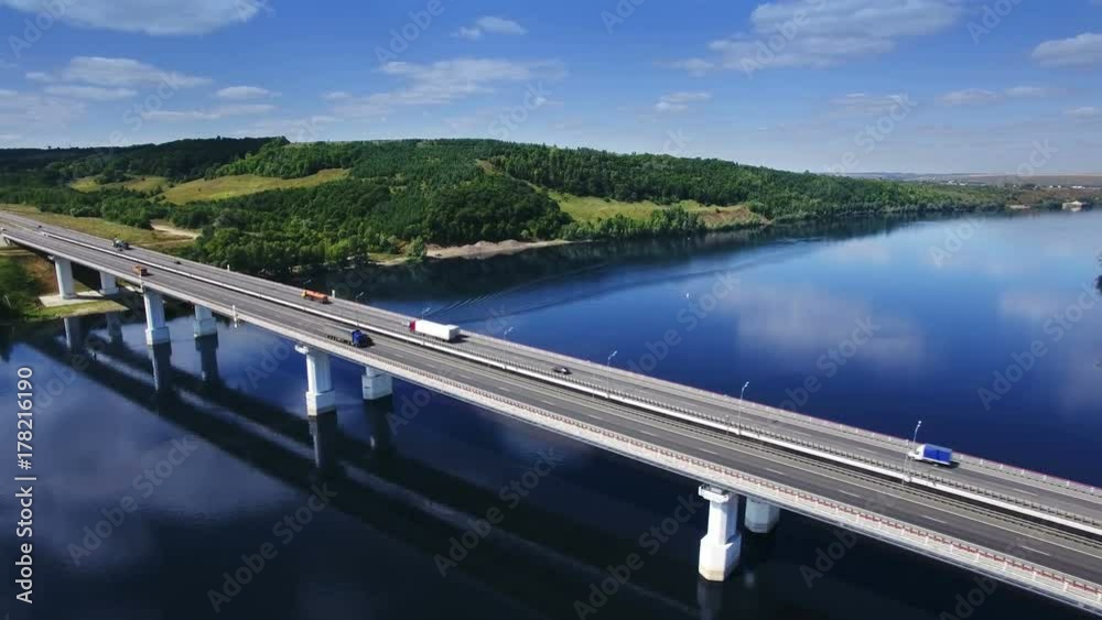 AERIAL Fly over traffic bridge highway roadway road way and blue river with trees forest, Europe, Russia, Tatarstan