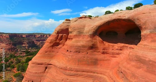 Panning Shot Of Red Sandstone Arch Against Blue Sky In Desert Landscape - Rattlesnake Arches In Colorado, USA