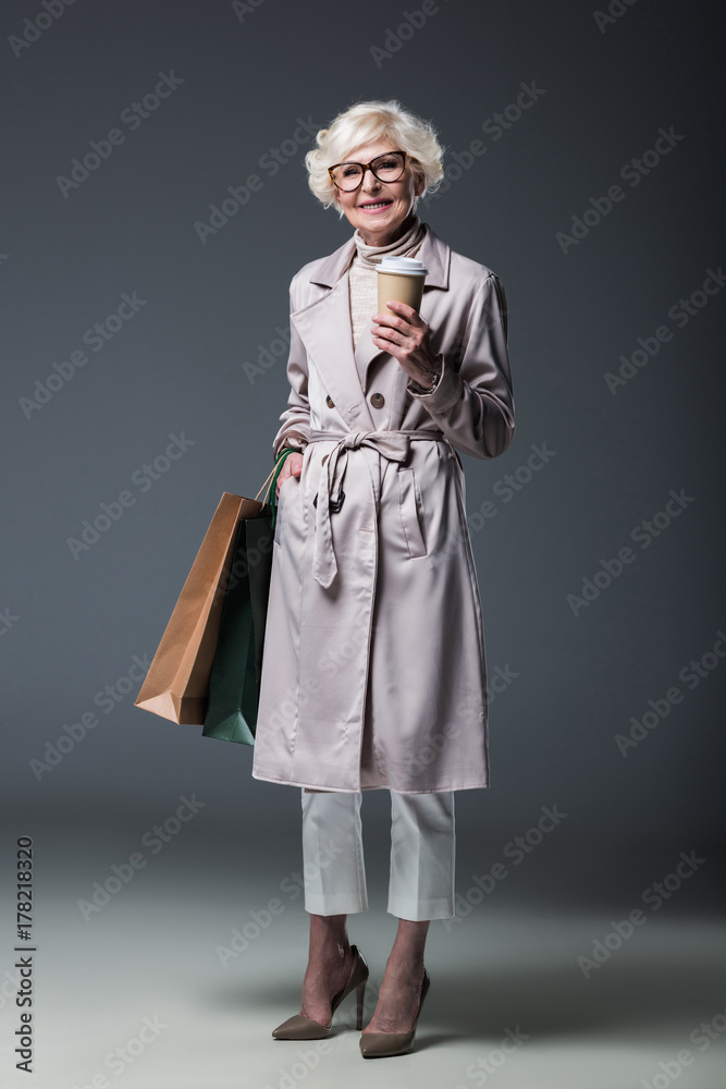 senior lady with shopping bags and coffee