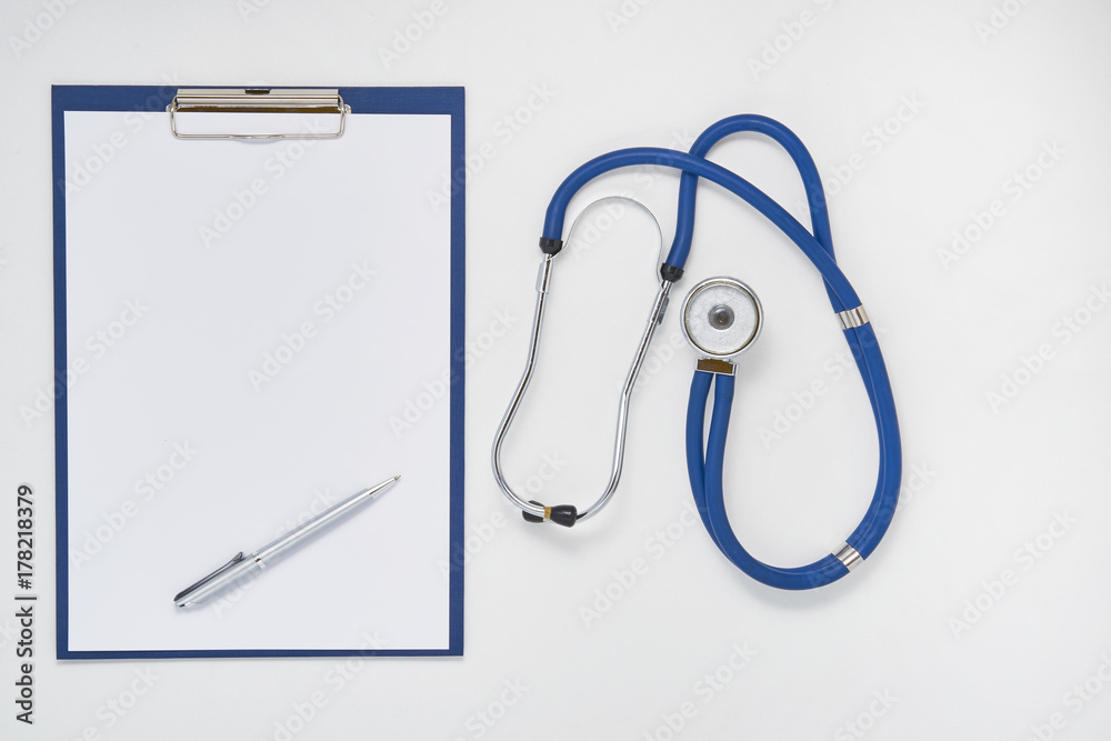 Doctor table with stethoscope, clipboard and pen, top view Doctor table with stethoscope, clipboard and pen, top view
