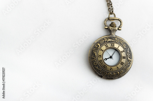 closed pocket watch on white background old