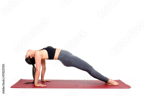 young asian woman doing yoga in Purvottanasana or Upward Plank yoga pose on the mat isolated on white background, exercise fitness, sport training, healthy lifestyle concept