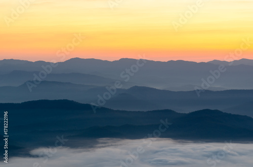 Sunset over mountains and fog