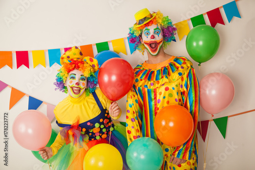 Two cheerful clowns. Birthday for children. Bright clown and clowness.