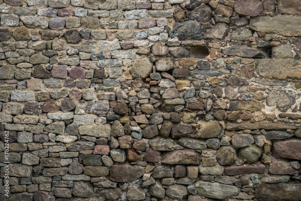 Fototapeta premium Texture of old rock wall for background, Medieval stone wall