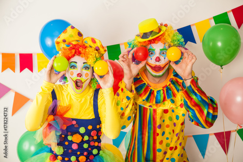 Two cheerful clowns. Birthday for children. Bright clown and clowness.