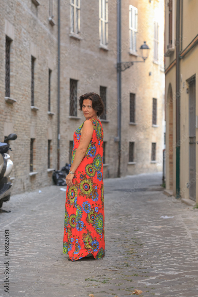 girl in red dress on the street in italy. girl in red dress on the street in italy.