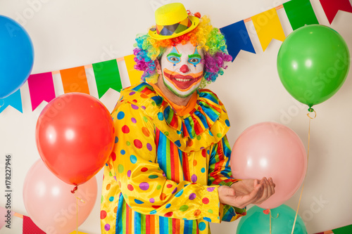 Bright cheerful clown. Birthday for children. Human emotions