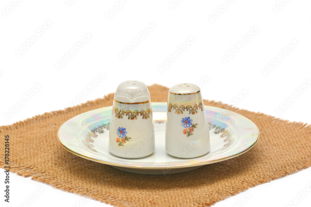 Salt and pepper containers on white background Salt and pepper containers on white background