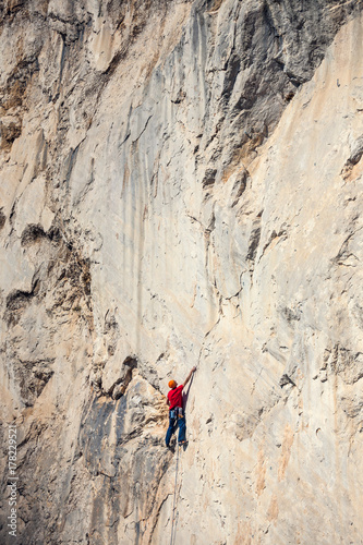A man climbs the rock.
