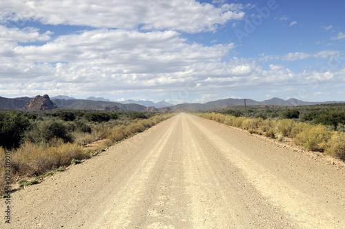 Desert Dirt Road with Mountain Range on the Horizon