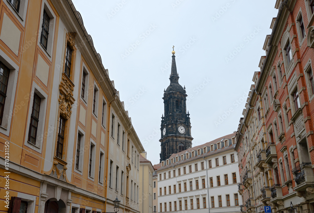 Dreikoenigskirhe Church tower above buildings on Rahnitzgasse Street, Dresden, Germany.