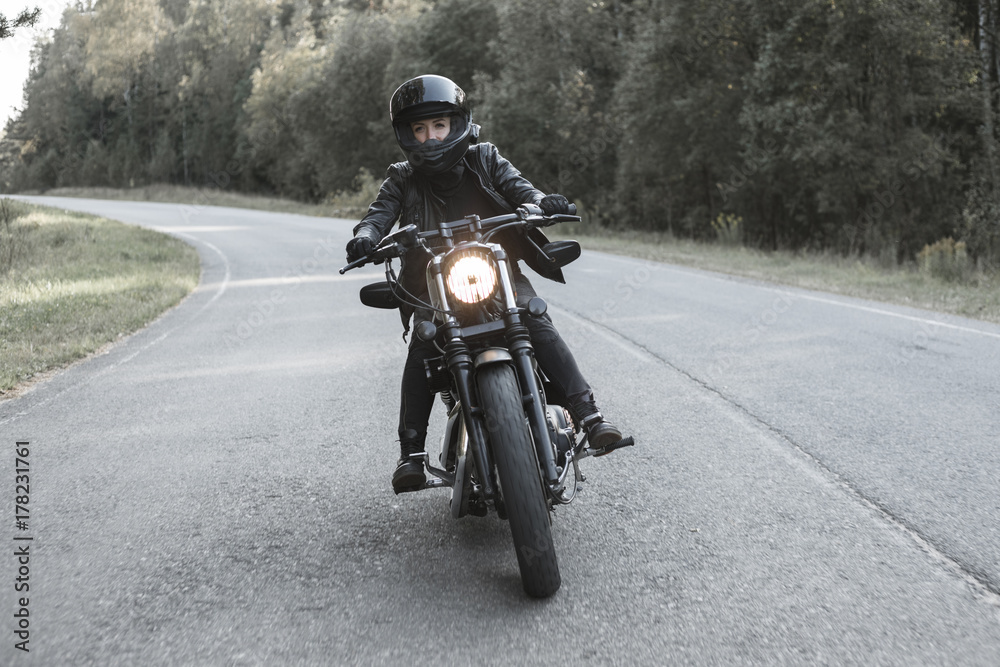 Fototapeta Young woman driving motorcycle