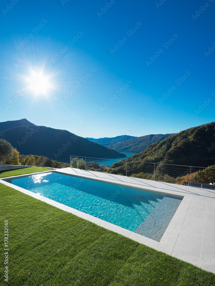 Modern swimming pool with lake and valley view