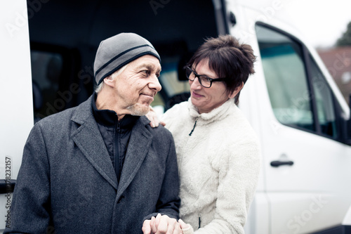 Nurse Helping Senior Man Enter A Van photo