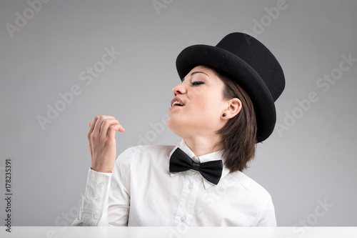 vain woman in top hat showing herself off