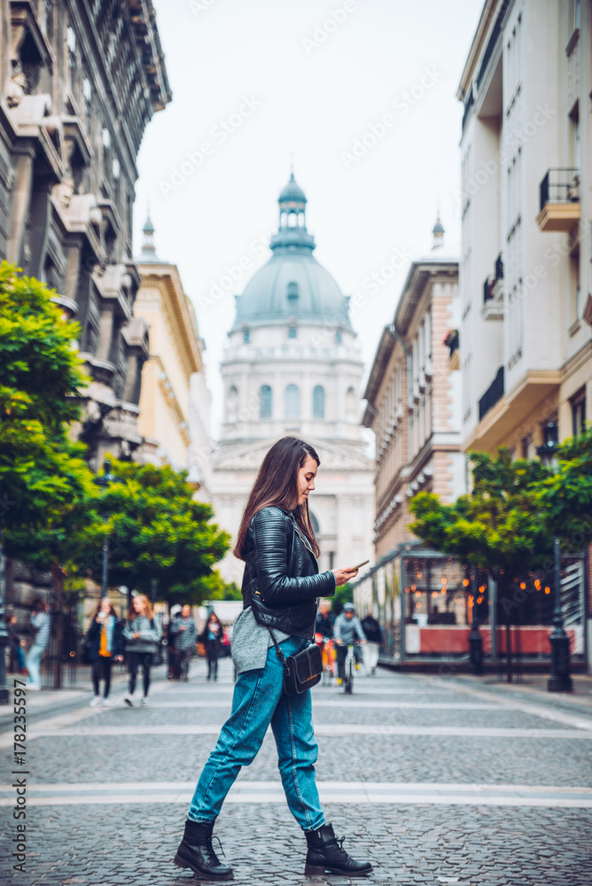 Obraz premium young pretty woman walk old european street with map
