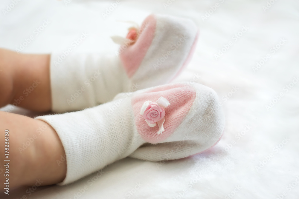 Legs of an infant in a booties Legs of an infant in a booties