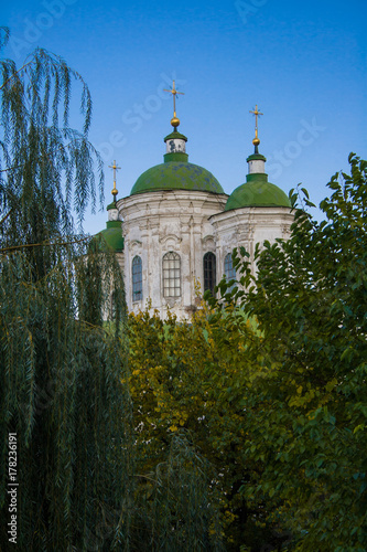 An old church among green trees