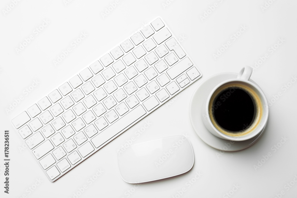 Office desk table with computer, supplies and coffee cup