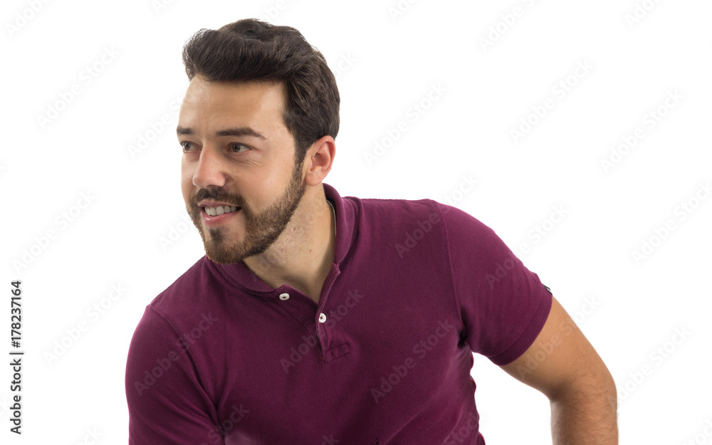 Man looks to the side. Half profile. Beautiful and bearded person. He is wearing a magenta polo shirt. Man looks to the side. Half profile. Beautiful and bearded person. He is wearing a magenta polo shirt.