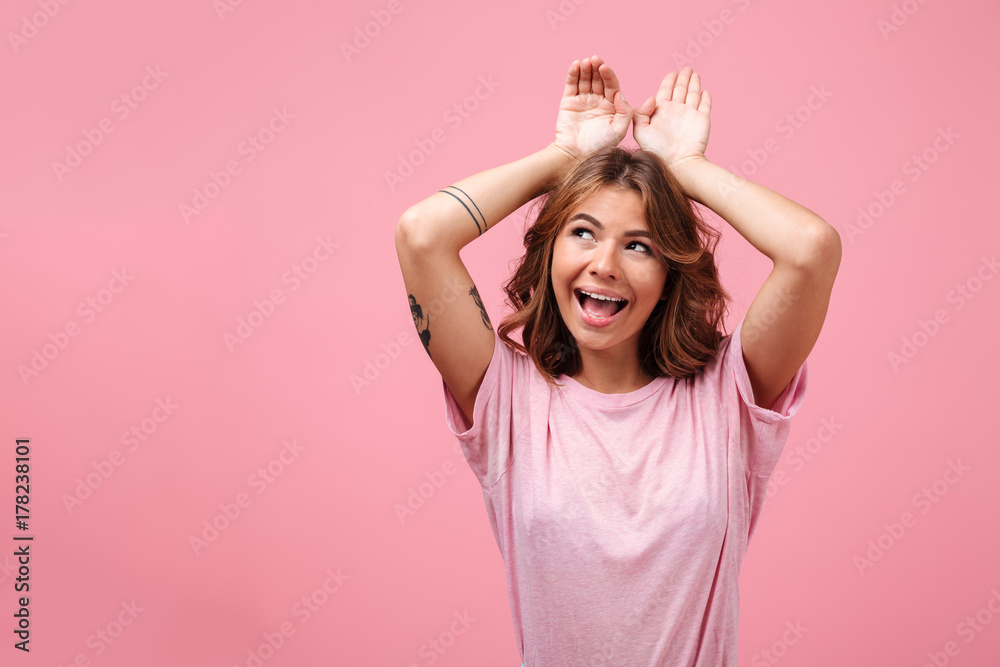 Pretty cute young lady gesturing with hands and looking aside. Pretty cute young lady gesturing with hands and looking aside.