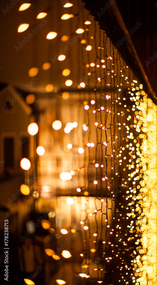Festive dark blurred background with bokeh lights, electric garland and  house Stock Photo | Adobe Stock