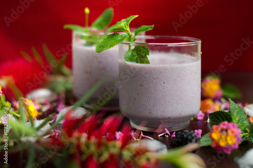 Delicious blackberry milkshake served ready to take. In the table