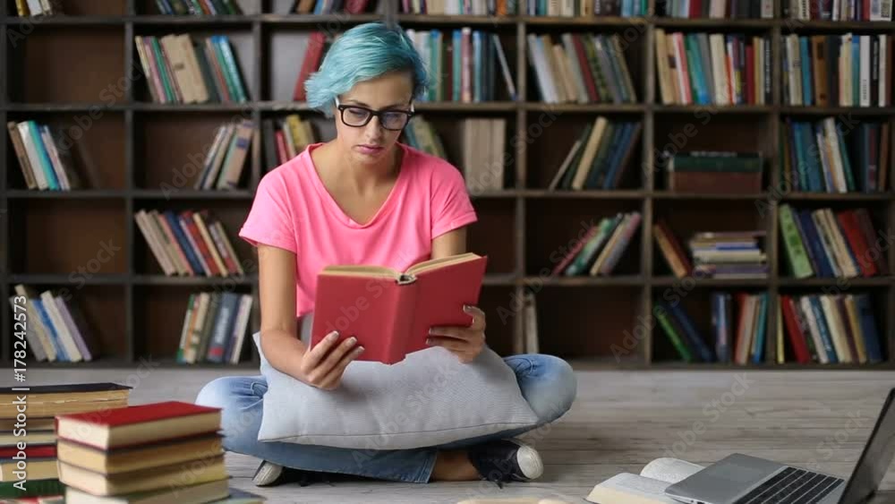 Frustrated overworked student girl reading a book