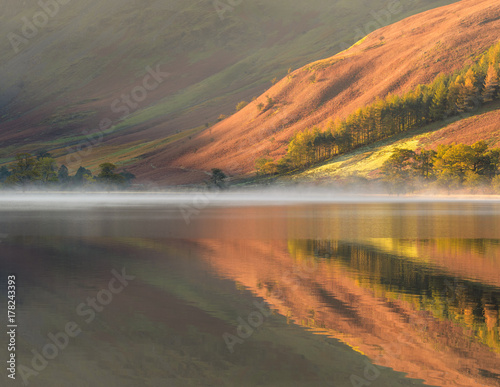 Autumn colors in reflection at Buttermere, Lake District photo