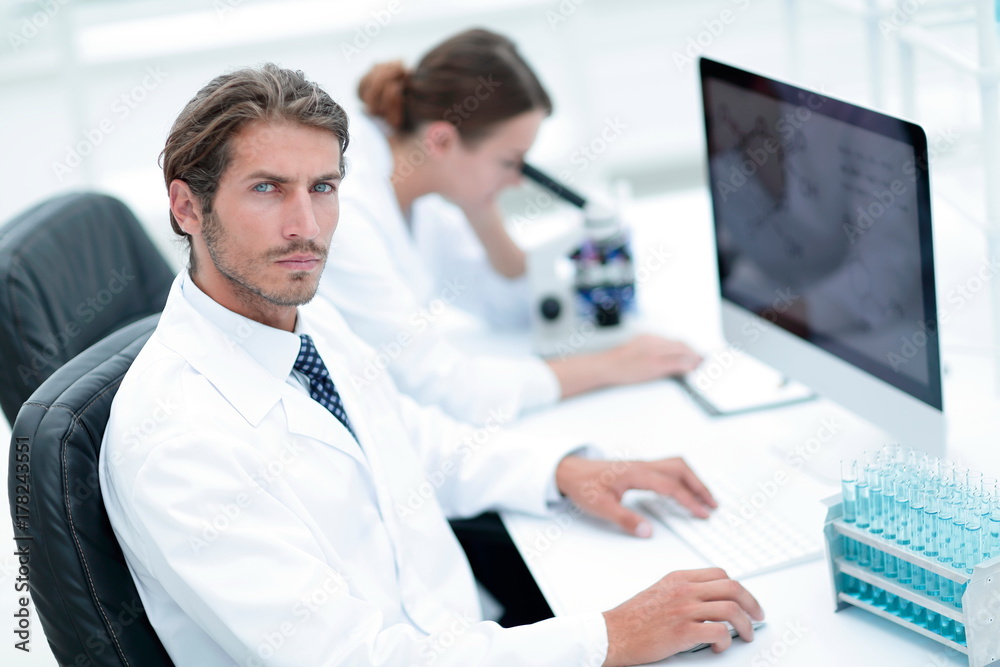 Fototapeta premium Young male technician working on computer in laboratory