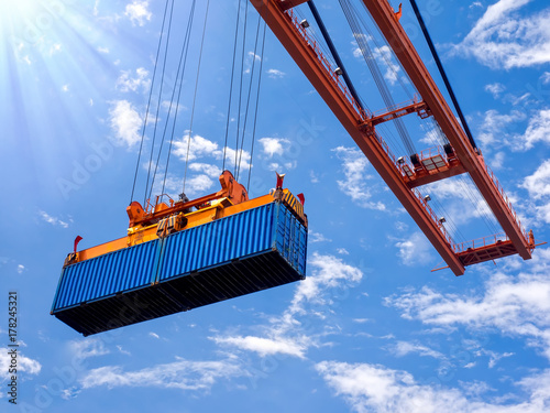 Industrial port crane lift up loading export containers box onboard at port of Thailand, Look up under the port crane operations.