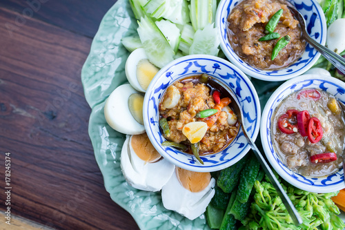 Thai food is 3 chili paste decorated with fresh side vegetables, boiled eggs.