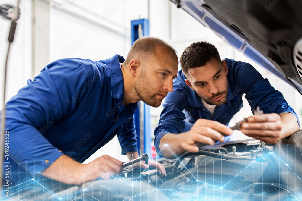 mechanic men with wrench repairing car at workshop mechanic men with wrench repairing car at workshop