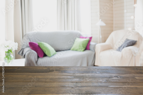 Blurred modern living room interior in rustic style with chair, soft divan. Abstract background for design.