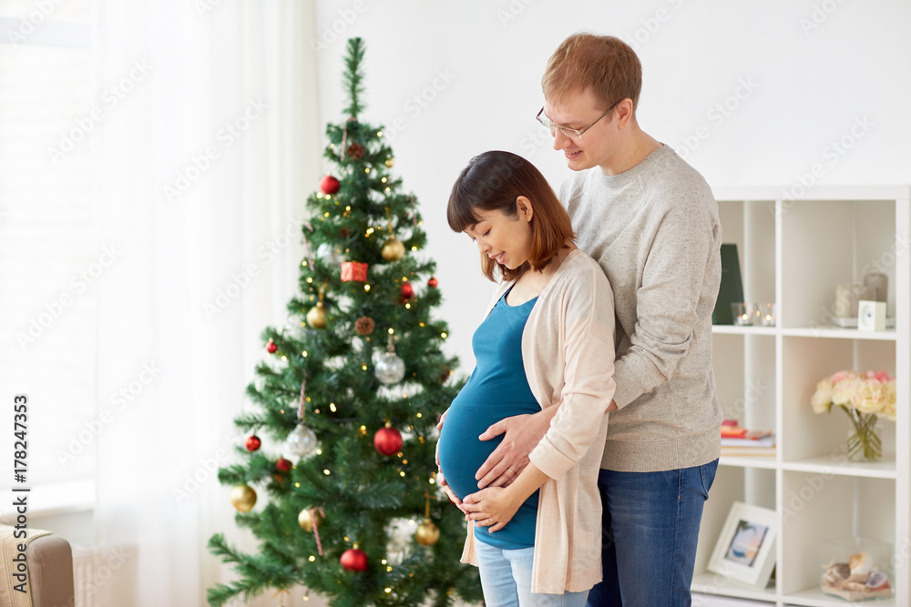 pregnant wife with husband at home at christmas pregnant wife with husband at home at christmas