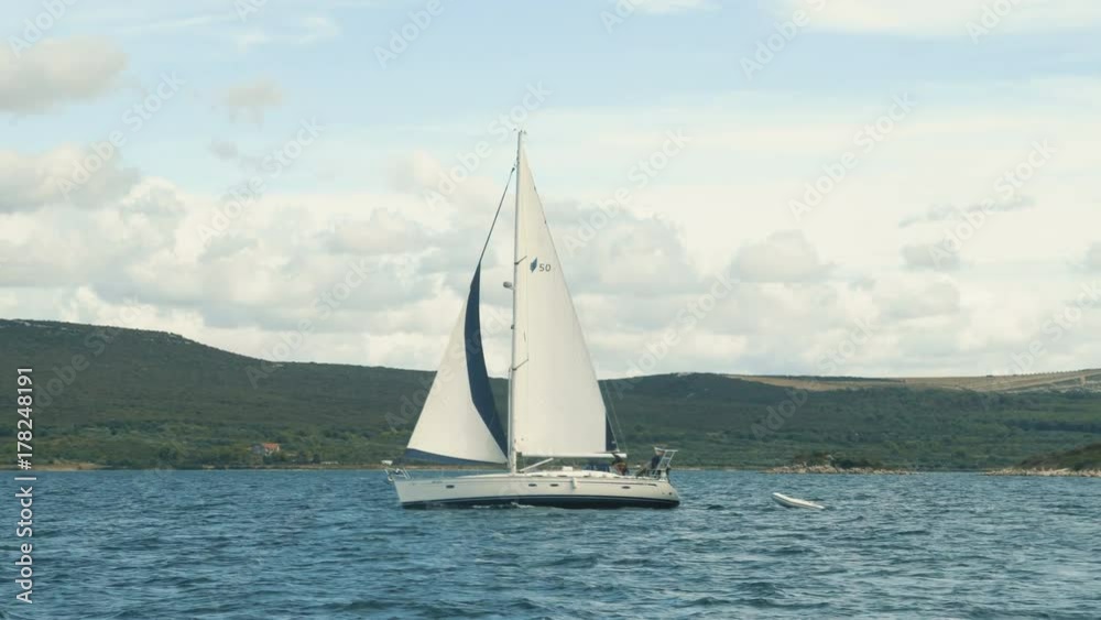 Sailing. Ship yachts with white sails in the Sea. Luxury boats. Boat competitor of sailing regatta. Sailing. Ship yachts with white sails in the Sea. Luxury boats. Boat competitor of sailing regatta.