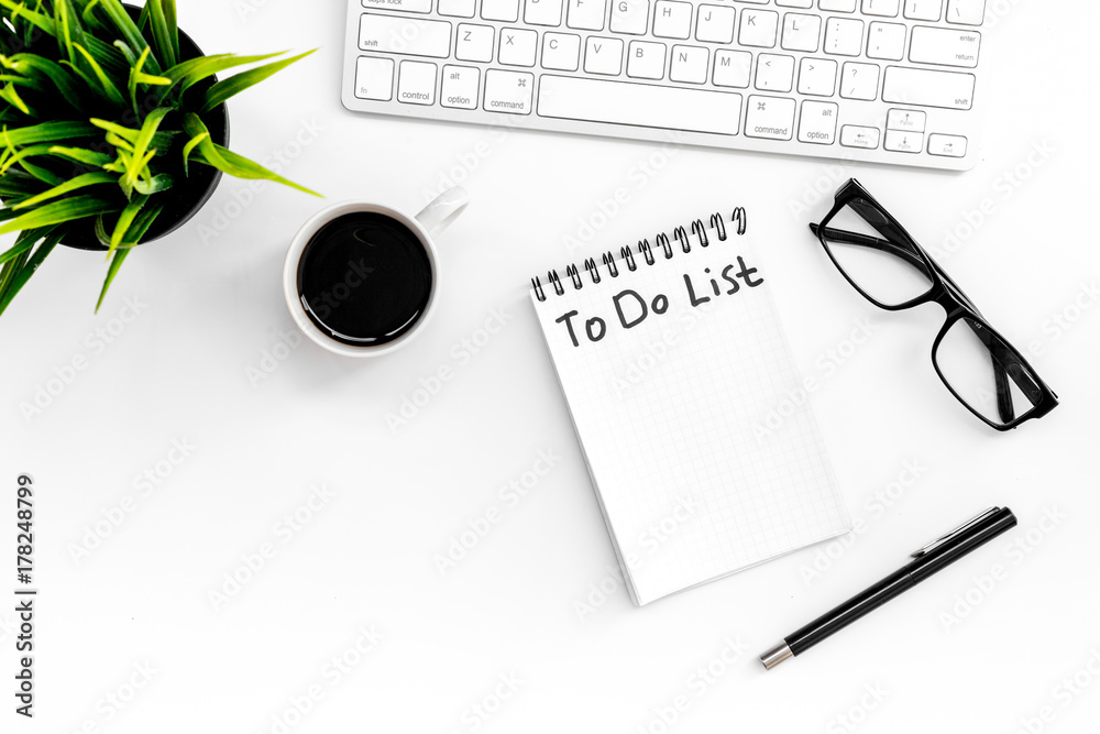 To do list for businessman in notebook on office table. White background top view copyspace To do list for businessman in notebook on office table. White background top view copyspace
