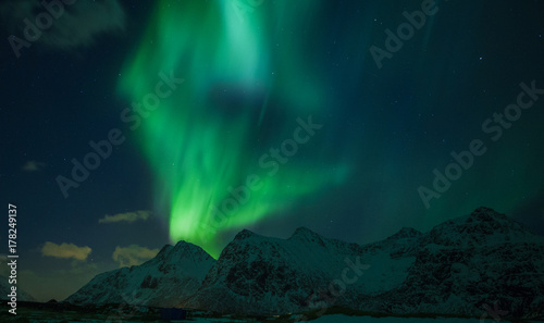 Northern lights  Aurora borealis  over the mountains. Norway  Lofoten