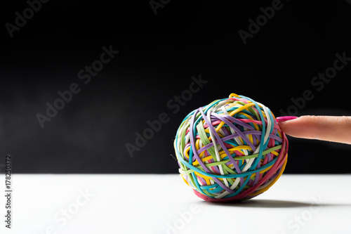 Woman's hand with colorful rubber bands ball