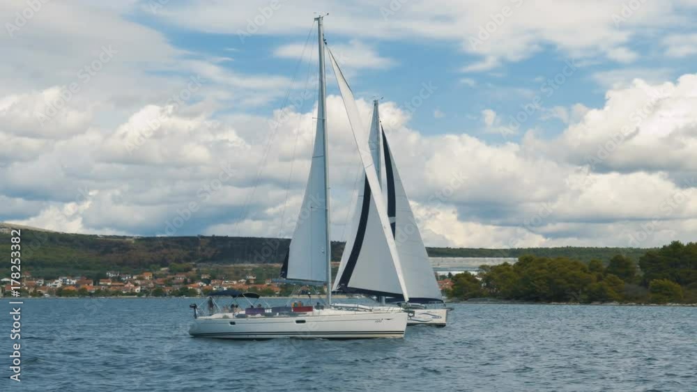 Sailing. Ship yachts with white sails in the Sea. Luxury boats. Boat competitor of sailing regatta. Sailing. Ship yachts with white sails in the Sea. Luxury boats. Boat competitor of sailing regatta.