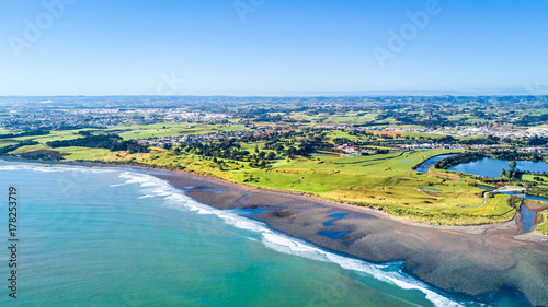 Aerial view on Taranaki coastline with a small river and New Plymouth on the background. Taranaki region, New Zealand