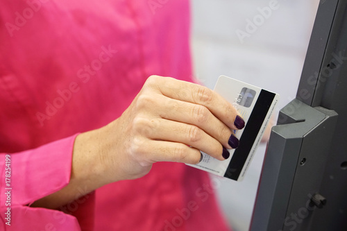 Credit card payment terminal in store. Seller draws up credit card purchases. close-up of a seller with a credit card