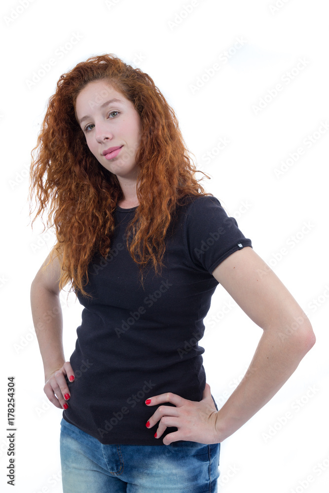 Young teenager, confident and happy. She is redheaded and young. White background. Black shirt..
