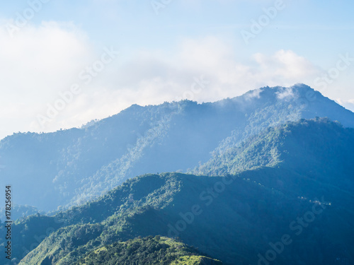 The late morning soft light toward the green range of mountain ridge at Doi Phu Wae in Nan province of Thailand. Such a great plentiful of green nature to visit