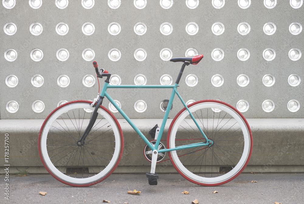 Fototapeta premium A City bicycle fixed gear on a green and white wall