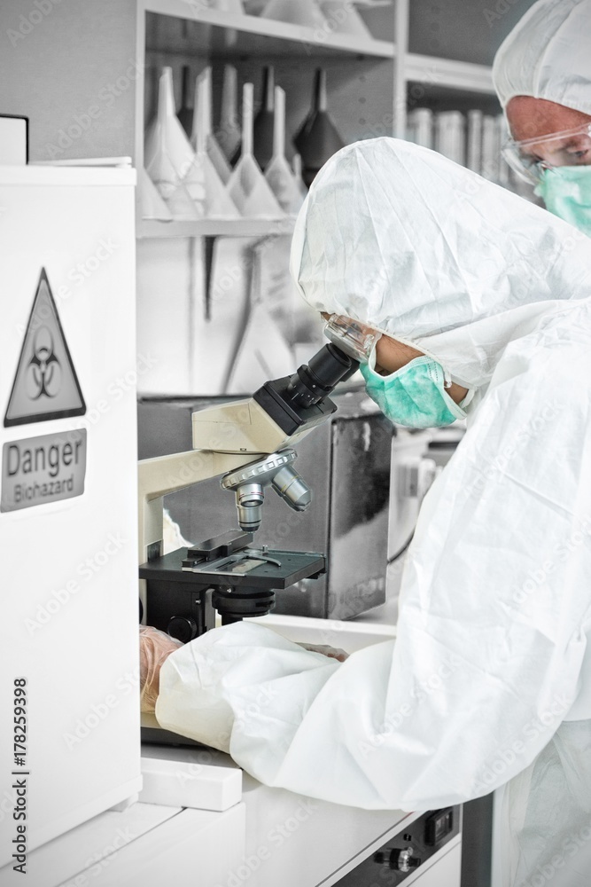 Scientist working on microscope Scientist working on microscope
