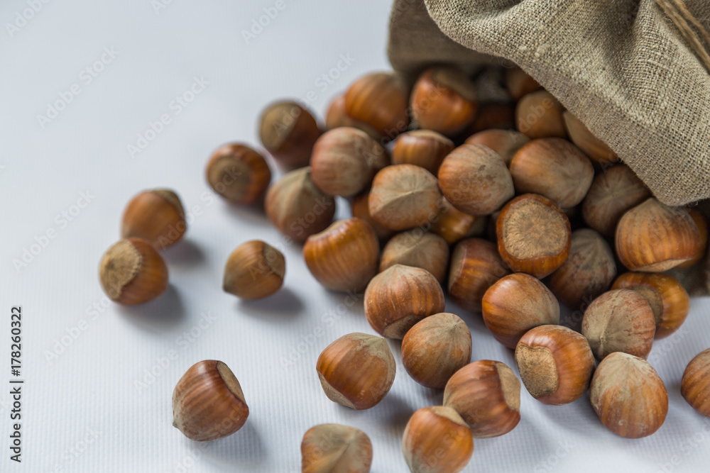 hazelnut on a white wooden background in a bag hazelnut on a white wooden background in a bag